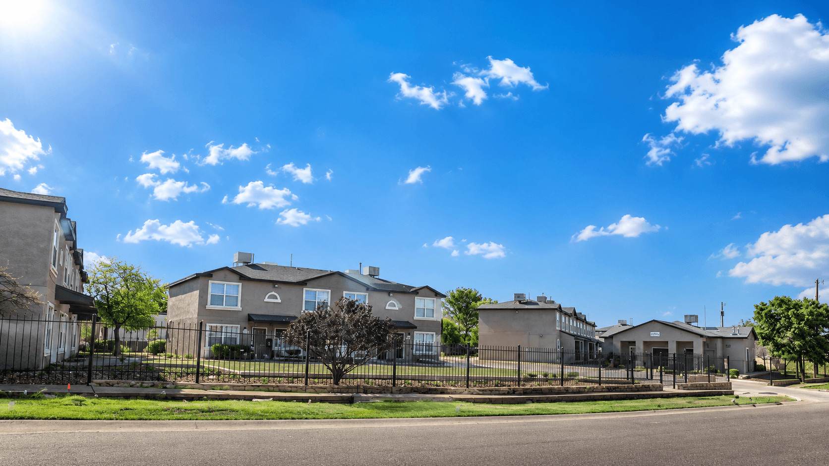 A row of houses with a clear blue sky above them.